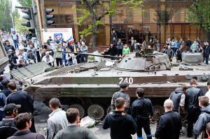 Civilains gather around tank in Mariupol